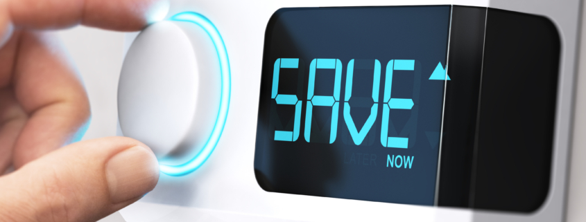 Hand turning a thermostat knob to increase savings by decreasing energy consumption. Composite image between a hand photography and a 3D background.